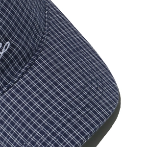 Detail of navy plaid visor featuring reinforced stitching and fine embroidery embroidery