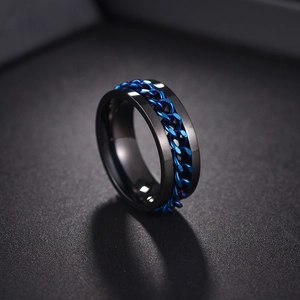 Macro detail of men's black titanium ring with rotatable blue curb chain inlay