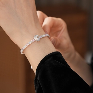 Close-up of elegant silver bracelet with pink and white zircon on a model's wrist