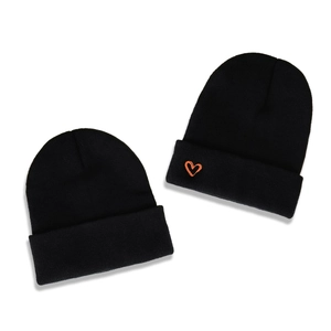 Set of two black knit beanies with orange heart embroidery and minimalist fold-over cuff