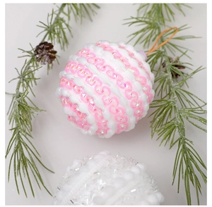 Close-up of pink and white macaron sequin Christmas foam balls with rustic pine cones