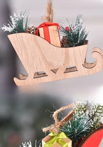 Detailed back view of wooden Christmas sleigh ornament with artificial snow and pine cone