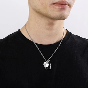 Silver titanium steel necklace with a square frame and round disc pendant on model