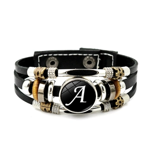 Detail of multi-layer black leather bracelet with beads and letter A charm