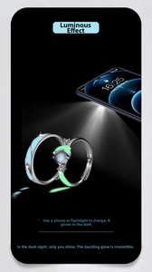 Luminous 925 silver couple rings showing blue and green glow under smartphone light