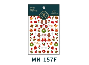 Macro detail of Christmas nail stickers with gingerbread man and festive holiday patterns