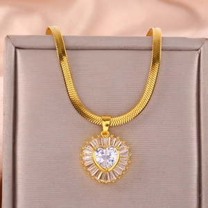 Detailed macro of gold snake chain with a radiant heart pendant and cubic zirconia stones