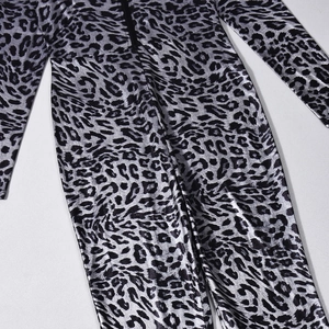 Macro shot of silver leopard print fabric with metallic texture and front zipper detail