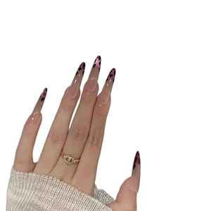 Pink almond press-on nails with leopard French tips and shimmering glitter accents