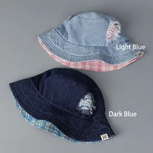 Stylish denim bucket hat with ripped details and pink plaid lining for women