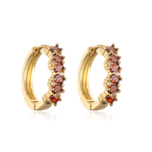 Detail of 18K gold plated hoop earrings with orange gems and micro-set cubic zirconia