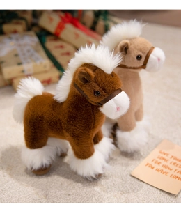 Detail of plush pony dolls with fluffy manes and tails in warm decorative setting