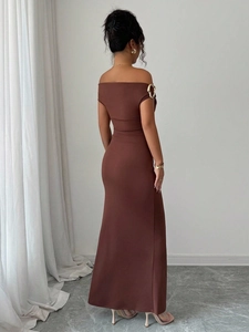 Detailed back view of an elegant brown off-shoulder evening maxi dress in knit fabric