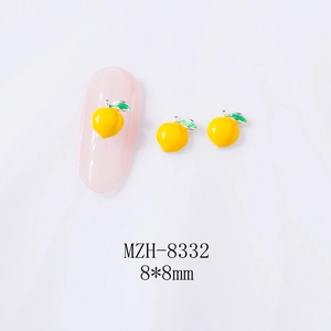 Detail of 8x8mm 3D lemon nail charms with green leaves on pink nails and white background