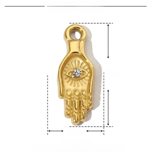 Macro shot of gold Hamsa hand pendant with crystal details and precise measurements