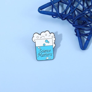 Science Matters enamel pin featuring a blue beaker design on a light blue surface