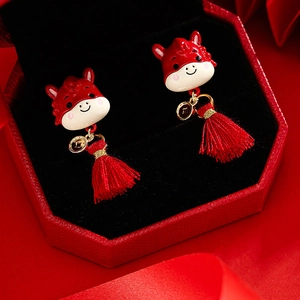Chinese New Year zodiac horse earrings with red tassels and gold coin charms in a gift box