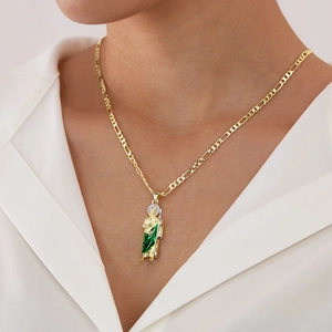 St. Jude pendant necklace in green and gold finish with Figaro chain on model neck