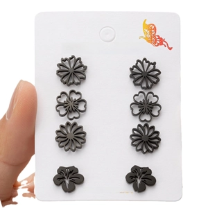 Set of four pairs of black stainless steel floral stud earrings with matte finish
