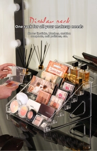Macro view of clear acrylic tiered organizer showing five layers for makeup storage