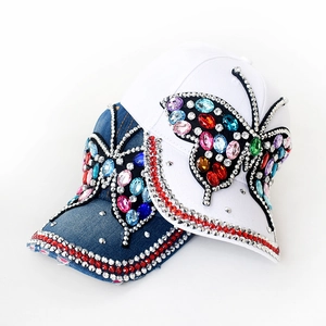 Close-up of sparkling colorful rhinestone butterfly and dual-row gems on baseball caps