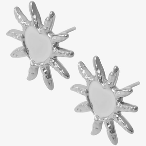 Detailed view of silver heart sun earrings with irregular lava texture and metallic finish