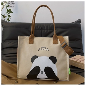 Close-up of beige canvas panda tote bag with 3D ears and brown adjustable strap