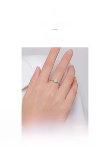 Detailed shot of an S925 sterling silver chain ring with a round green opal gemstone