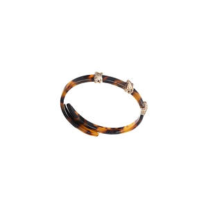 Vintage leopard resin open cuff bracelet with gold accents on white background