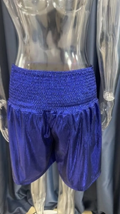 Detail of blue purple metallic shorts featuring elastic high waist and shiny fabric texture