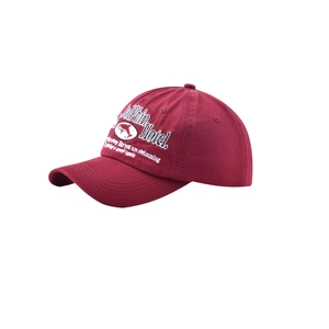 Detail of white Dolphin Hotel embroidery on a vintage dark red cotton baseball cap