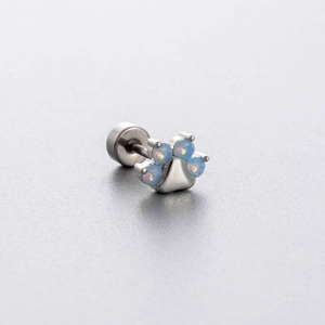 Titanium steel cat paw stud earring with blue opal stone inlay on a clean background