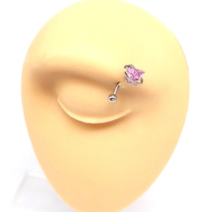 Close-up of a silver eyebrow ring with pink heart gem and Saturn design on a model