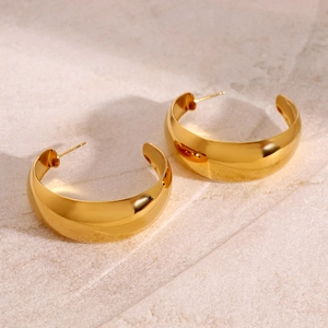 Minimalist chunky 18k gold plated stainless steel C-shaped hoop earrings on stone background