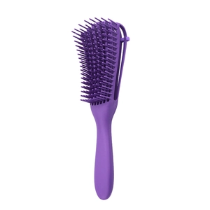 Detail view of the ergonomic curved purple detangling brush head with flexible multi-row bristles