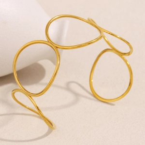 Detail of 18K gold plated minimalist open bangle with nested irregular geometric rings