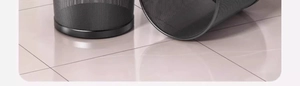 Detailed view of two black metal wire mesh waste bins placed on a modern tiled floor