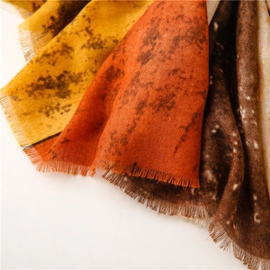 Detailed shot of gradient ink painting scarf with fringe and soft linen texture