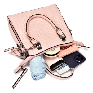 Pink woven handbag interior showing spacious capacity for umbrella, phone, and cosmetics