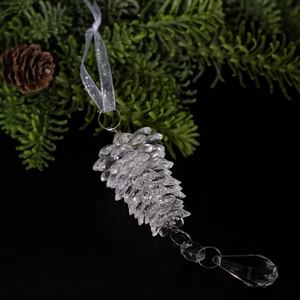 Transparent acrylic pine cone Christmas ornament with crystal finish on a dark background