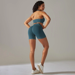 Close-up of seamless dark teal yoga set showing high waist shorts and racerback sports bra