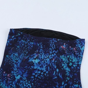 Detail shot of the abstract blue print mini dress featuring clean stitching and black lining