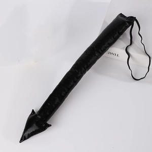 Detail of glossy black devil tail accessory with arrow tip and elastic band