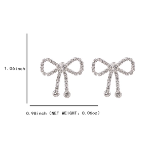 Silver bow knot stud earrings with tassels and white rhinestones for a chic look