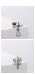 Detail view of steel helix earrings with blue stones and screw back balls on white steps