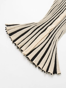 Detail of striped knit texture with white resin buttons and wavy ruffle hem finish