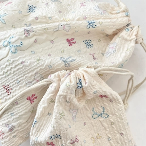 Detail of quilted cotton drawstring bags with cute rabbit and bow patterns