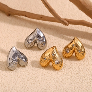 18K gold plated heart stud earrings with stars and rhinestones on sandy texture