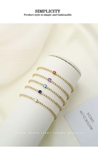 Detail of five-piece gold tennis bracelets set with colorful round cubic zirconia stones