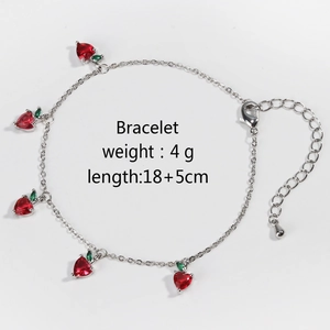 Silver strawberry charm bracelet featuring red cubic zirconia and green leaf accents
